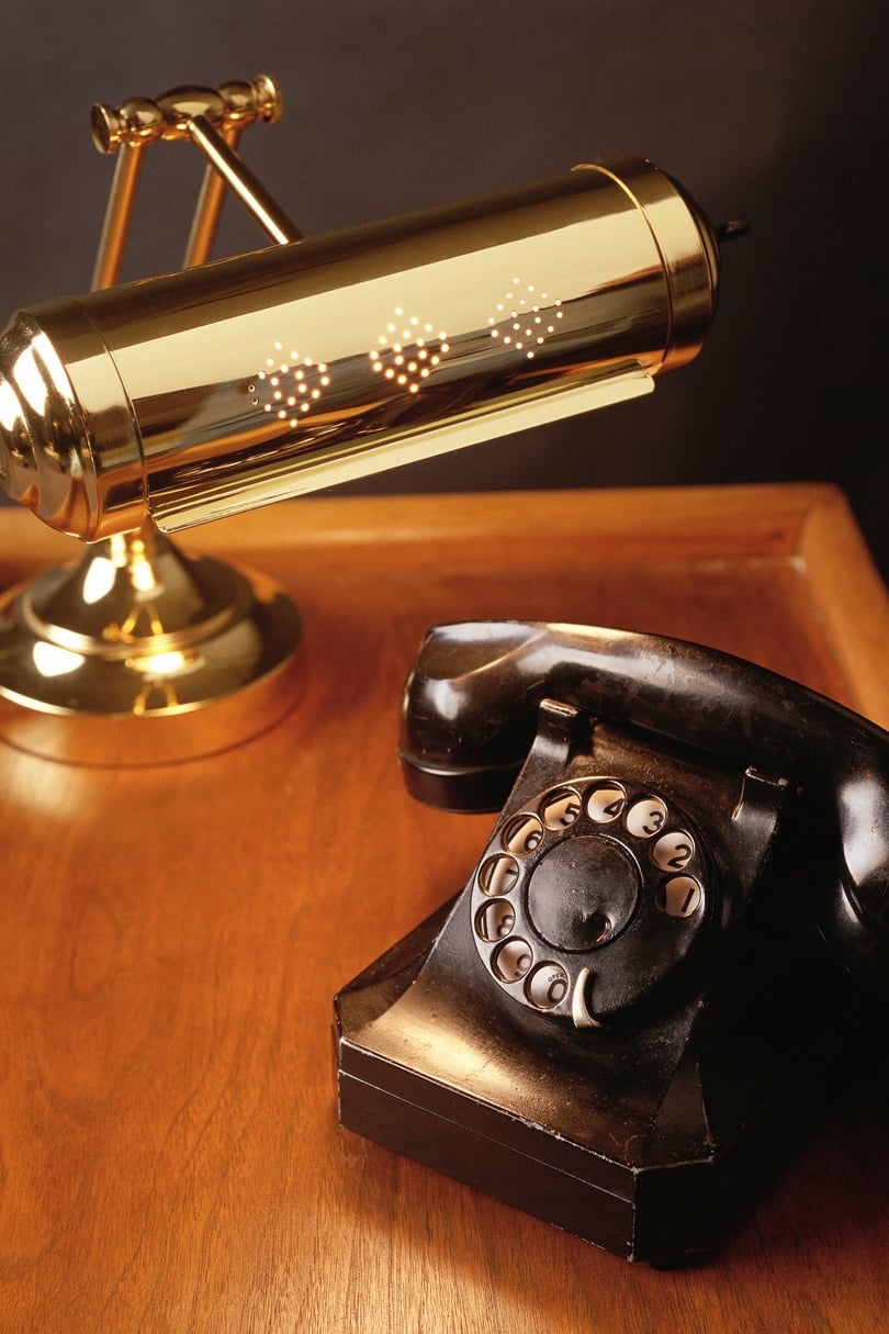 Desk with brass lamp and antique phone